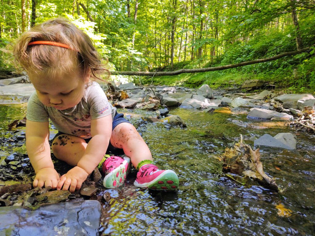 child playing in stream